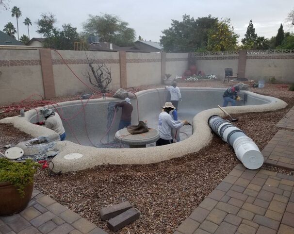 Attached image file profession renovation team working on resurfacing a pool